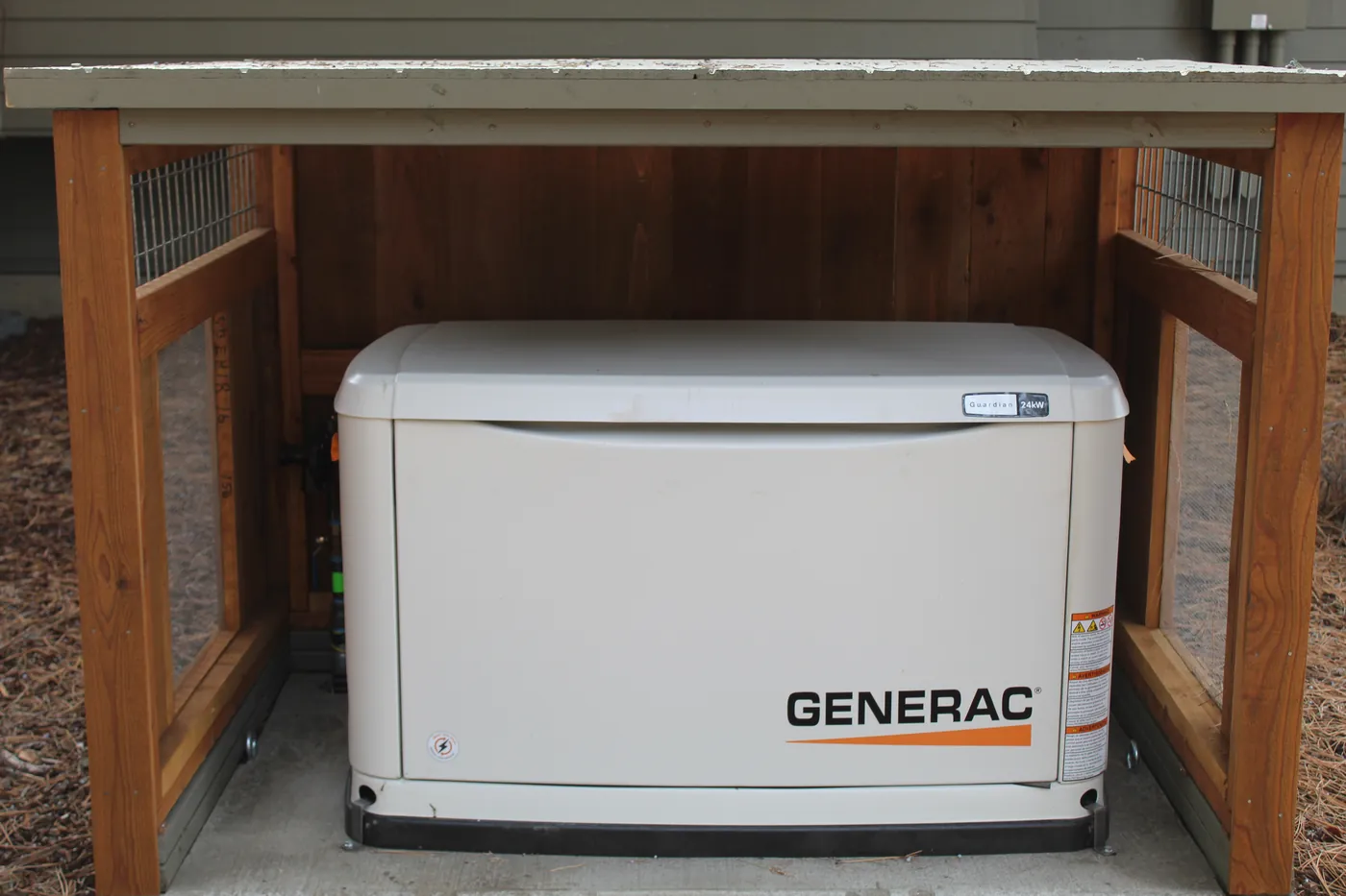 A standby generator inside a slatted cedar enclosure