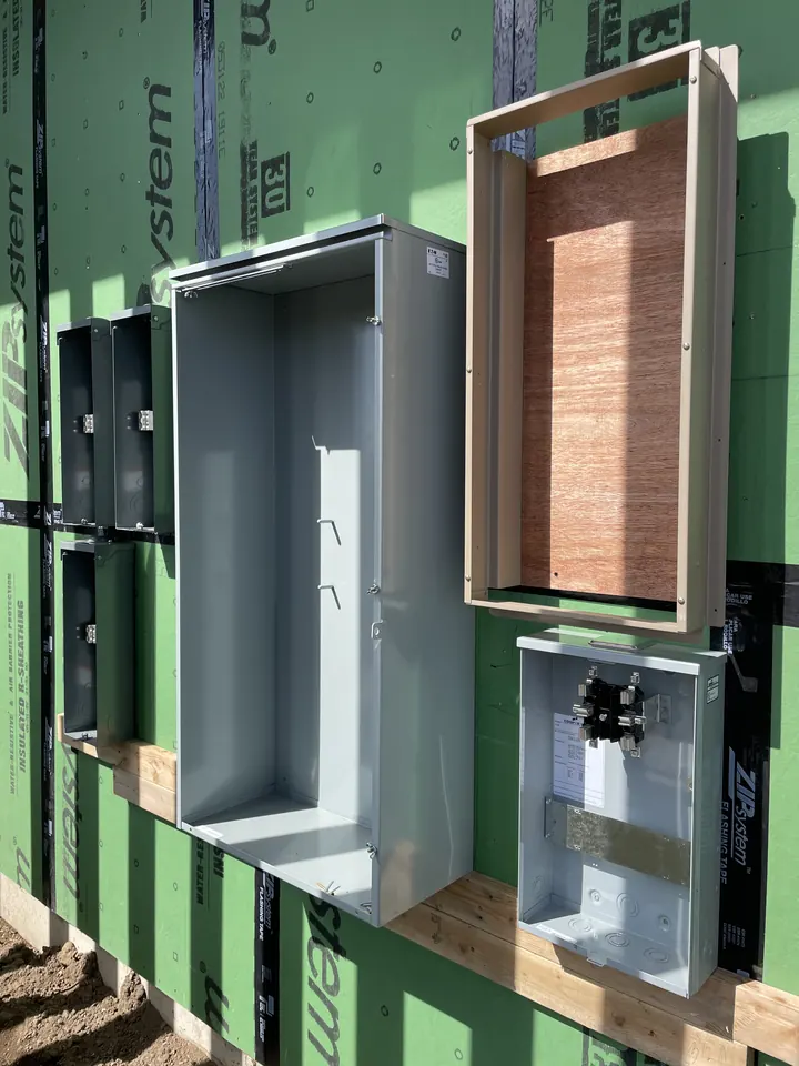 Electrical enclosures mounted on green sheathing on a new build