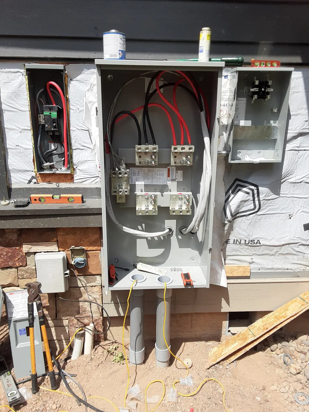 A new meter base and service panel on a house under construction